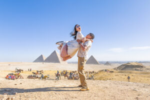 Eric lifting Kamy in the air at the Pyramids of Giza.