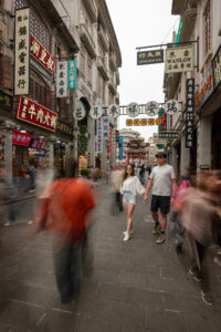 Kamy and Eric holding hands walking in a Chinese old town street.