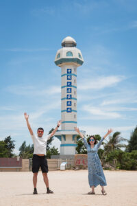Kamy and Eric in front of the lighthouse at the southermost point of Chinese Mainland.